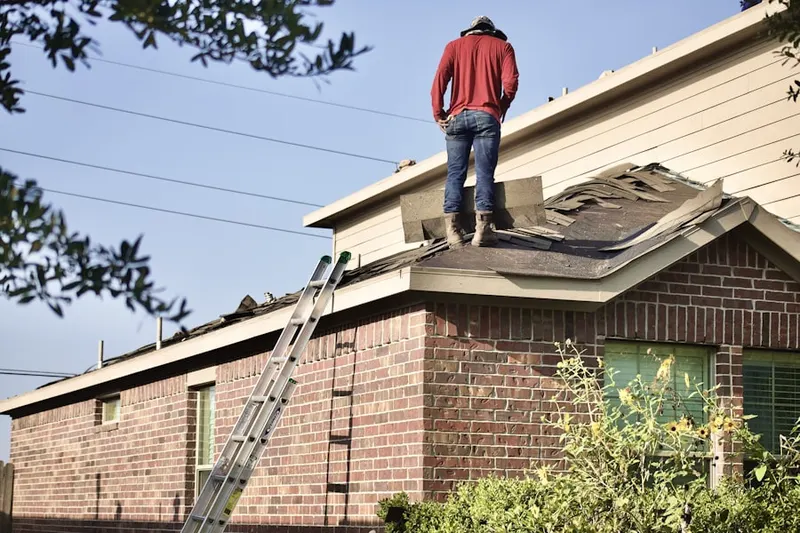 Professional roofer working on a residential roof in Glen Mar Park